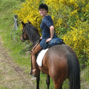 Dr. Hannah riding Cricket a rescue horse on the trail
